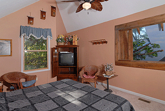 king size bed with an overlook to the living room