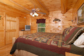 Pigeon Forge Cabin That offers a large master bedroom that has tv and dvd player