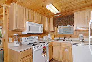 cabin fully equipped kitchen with stove and dishwasher