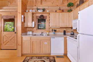 Pigeon Forge Cabin Rental that features a fully equipped kitchen.