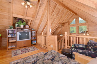 Pigeon Forge One Bedroom Cabin Rental that feautres a loft overlooking the livingroom and kitchen area