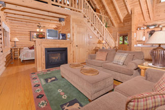 Pigeon Forge One Bedroom Loft Cabin Rental that features 2 living room areas and a year round hot tub.