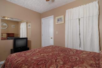 bedroom with queen size bed and tv