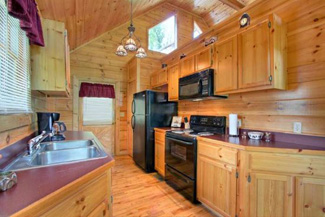 Large Kitchen in this 2 bedroom cabin with Cathedral Ceiling on the main level, with a fully Equipped kitchen with coffee maker,dishwasher,microwave, Unstocked Refridgerator