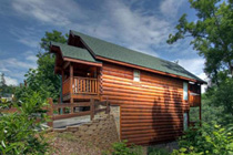 Pigeon Forge 2 bedroom cabin in the smokies with log exterior and interior that has a hot tub pool table and a view of the mountains. No view of a river but you can hear one in the distance.