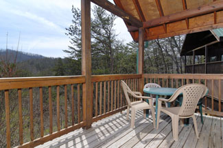 Tennessee Cabin Rental with outdoor rockers on a large covered deck overlooking the Smokies