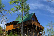 Log cabin on a hill side near an outdoor swimming pool