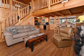 Pigeon Forge One Bedroom Plus Loft Livingroom Area that features a queen size sleeper sofa and recliner
