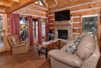 Pigeon Forge One Bedroom Plus Loft Cabin Rental Livingroom Area that features a Theater System-Foosball Table-Gas Fireplace- Mountain View