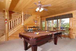 Tennessee Smoky Mountain Cabin Rental that features a lower level game room that has a pool table and plenty of seating for the whole family
