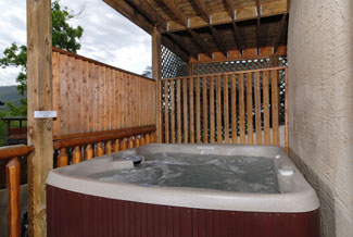 Pigeon Forge four bedroom cabin that features an outdoor hot tub