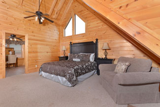 Pigeon Forge 4 Bedroom Cabin rental with a private master suite on the upper level.