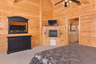 Pigeon Forge TN Vacation Cabin Rental that features an upstiars masterbedroom with a flat screen television
