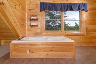 Pigeon Forge Cabin that features an indoor whirlpool in the upstairs master bedroom that has a mountin view