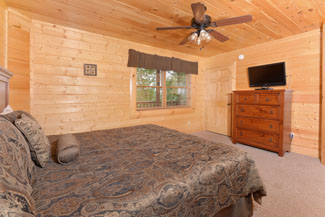 Pigeon Forge Vacation Cabin Bedroom with a flat screen tv and a king size bed