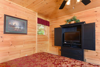 Pigeon Forge Four Bedroom Cabin Rentals with a flat screen television