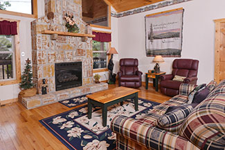 Pigeon Forge Cabin Rental Main Level Livingroom With a Flat Screen Television and a Gas Fireplace