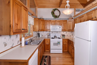 Tennessee Vacation Cabin Rental that features a fully Equipped Kitchen that leads to the covered back porch