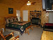 Log furniture and charming rustic decor complete the atmosphere in this lovely master bedroom