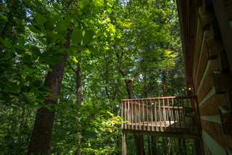 Pigeon Forge One Bedroom Cabin Rental Outdoor Porch Area with a Wooded View