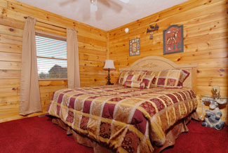 Pigeon Forge Three Bedroom Cabin Rental that features a Flat Screen TV in the Bedroom