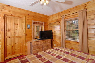 Pigeon Forge Cabin Bedroom that features a flat screen tv for your own private television enjoyment