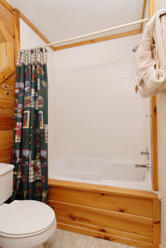 Pigeon Forge Three Bedroom Cabin that features a bathroom with a whirlpool tub