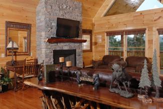 Tennessee Vacation Cabin Rental that has a flat screen television and a gas fireplace in the spacious living room area on the main level of the cabin