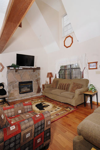 Pigeon Forge Chalet that features a lofted living room that has a flat screen tv and gas fireplace