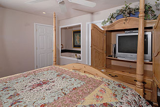 king size bed facing a tv hutch