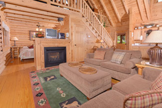 Pigeon Forge One Bedroom Loft Cabin Rental that features 2 living room areas and a year round hot tub.