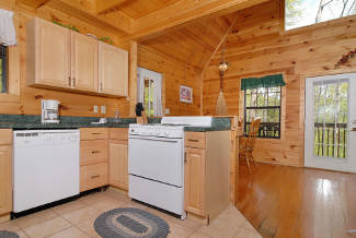 cabin with fully equipped kitchen and dining area