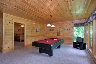 Gameroom area that features a pool table, tv, and futon