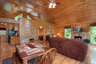 Cabin living room surrounded in elegant wood with cathedral ceilings