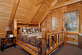 Stout log bed with quilt in the loft 