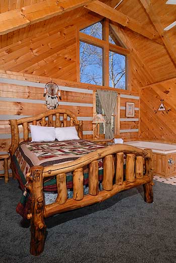 Storybook bedroom setting with log bed and whirlpool tub