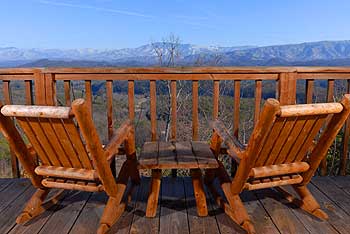 Deck table and chairs overlooking that incredible mountain view