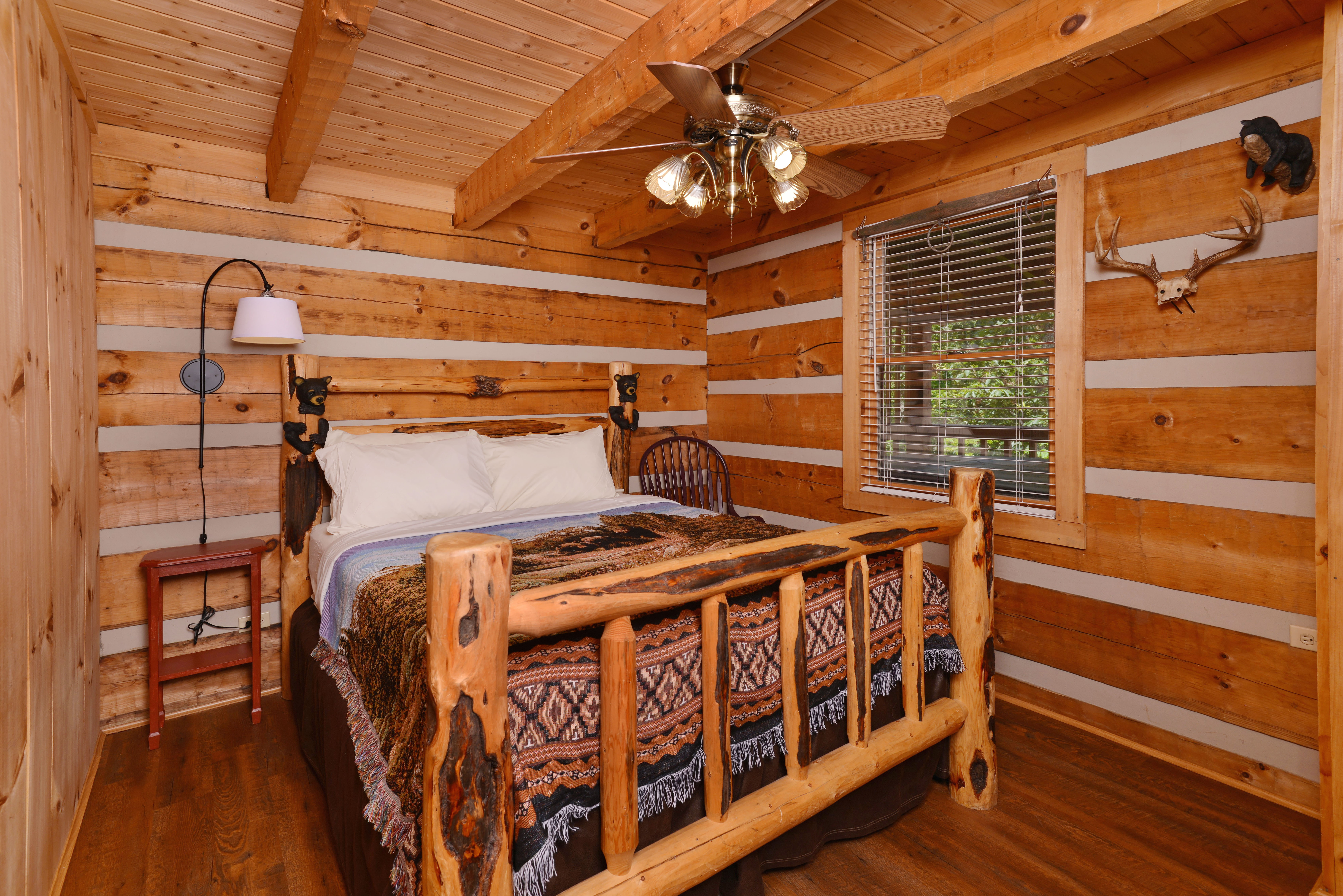 Pigeon Forge Cabin Rental Main Level Bedroom with Queen Size Bed and Large Flat Screen Television