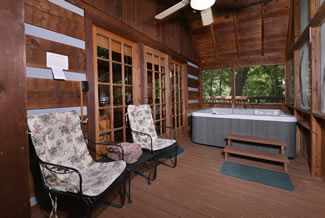 Pigeon Forge Screened in Porch Area featuring outdoor seating and a gas grill