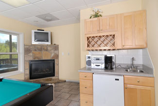 Pigeon Forge Chalet Game Room Area that has a pool table kitchennette and a seating area