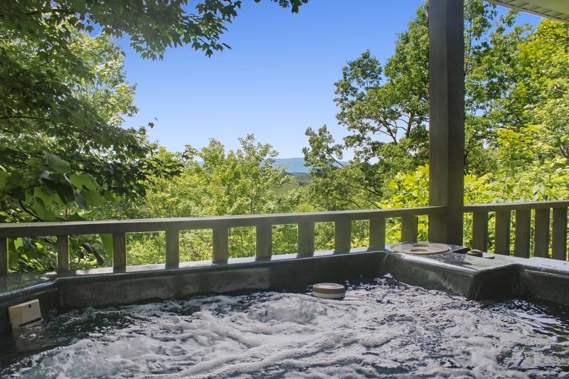 The Hidden End hot tub with mountain view