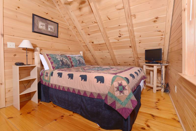 Pigeon Forge Cabin Queen Size Bed in the Bedroom with Flat Screen Television