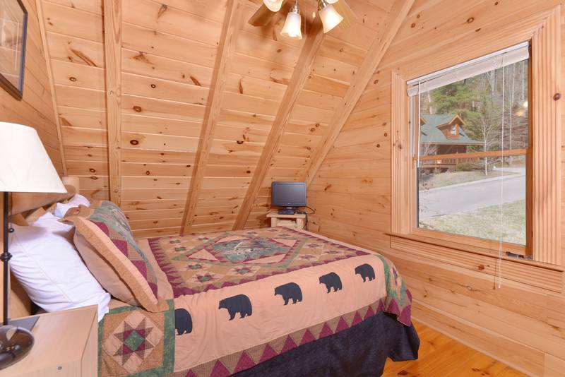 Pigeon Forge Cabin Queen Size Bed in the Bedroom with Flat Screen Television