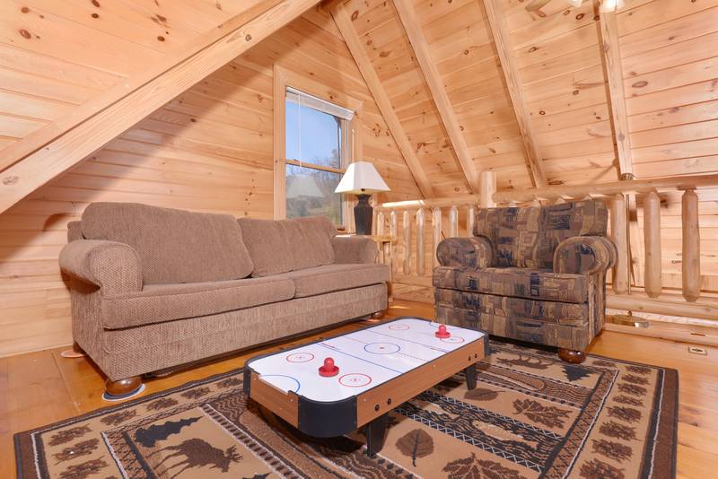 Pigeon Forge Cabin with a Lofted seating area with a miniature Air Hockey Table