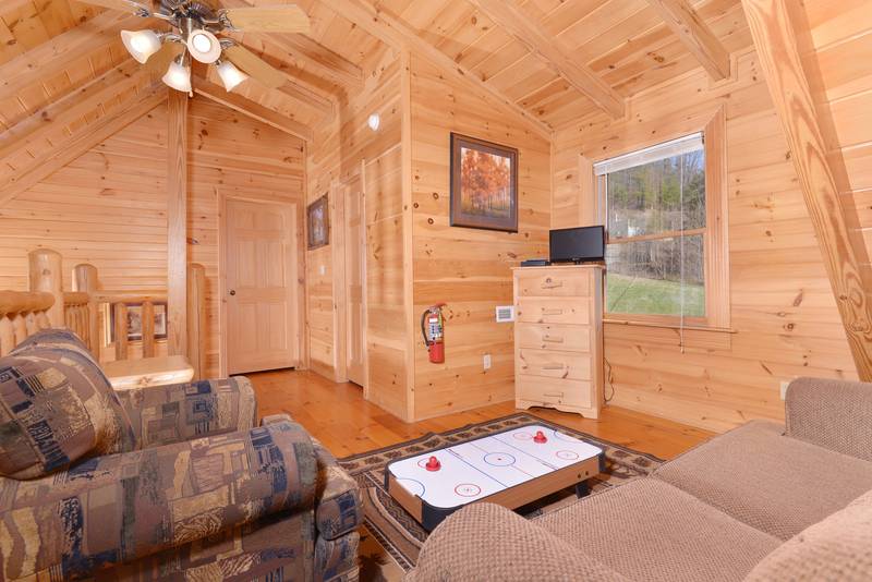 Pigeon Forge Cabin with a Lofted seating area with a miniature Air Hockey Table