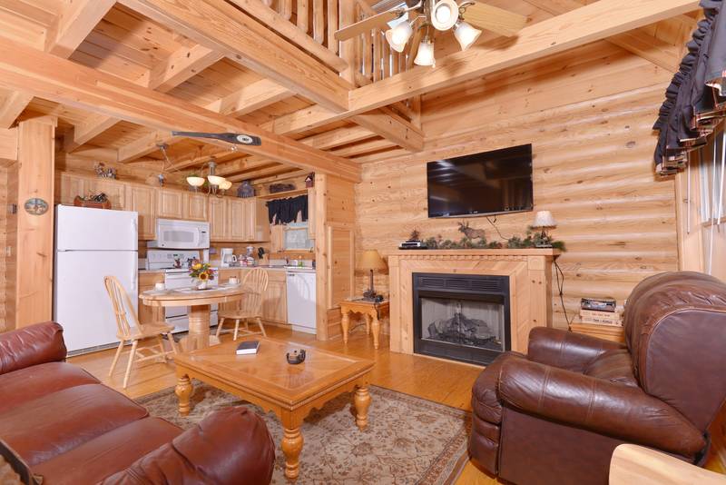 Pigeon Forge Cabin Living Room Area with a Gas Fireplace and Flat Screen Television