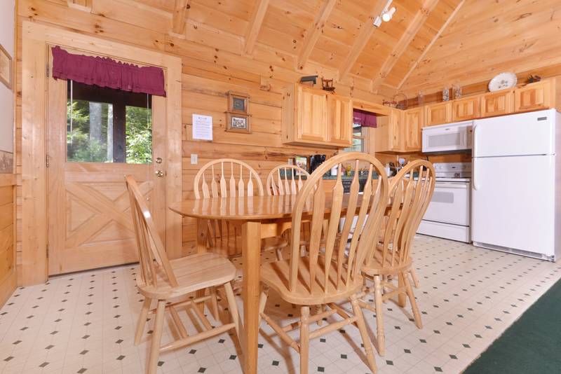 Pigeon Forge Two Bedroom Cabin that features seating for 6 at the kitchen table