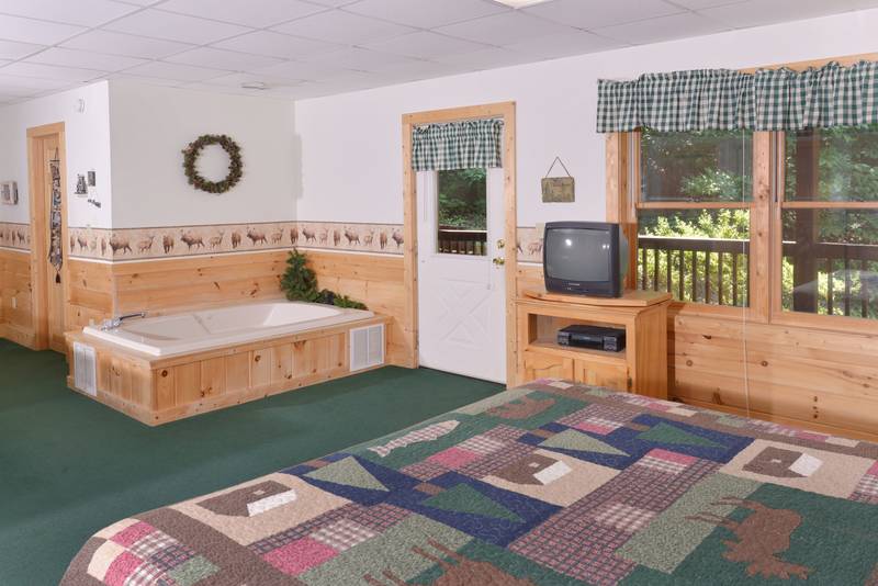 Pigeon Forge Two Bedroom Cabin Rental featuring a King Size Bed in lower level master suite