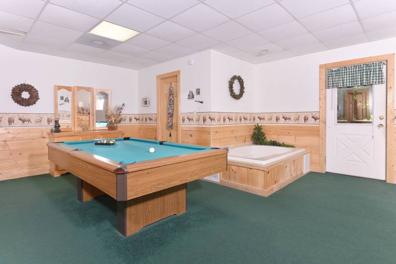 Pigeon Forge Cabin Bedroom that features a King Size Bed,Whirl Pool, and a Pool Table