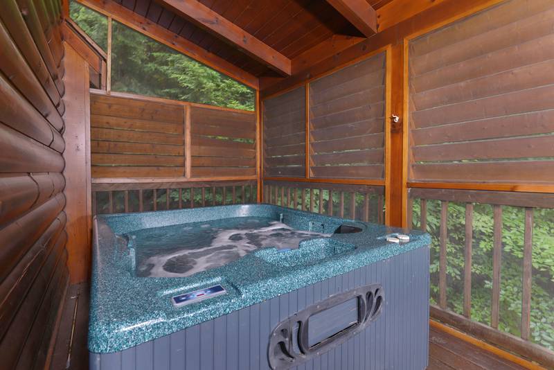 Pigeon Forge Two Bedroom Cabin Rental with an outdoor hot tub, great for any season